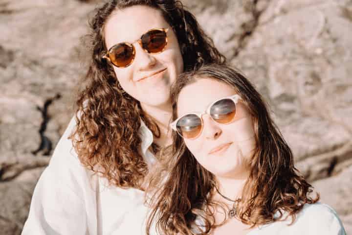 two-woman-in-sunglasses-smile-for-the-camera